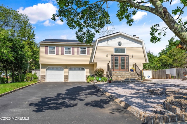 5 Maplecrest Ct, Toms River, NJ 08753 - view of front of property featuring french doors, asphalt driveway, a gambrel roof, an attached garage, and stone siding