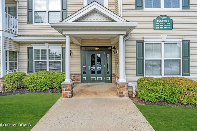 215 Sloan Ct, Matawan, NJ 07747 - view of exterior entry with a lawn