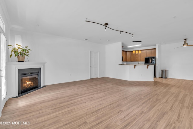 215 Sloan Ct, Matawan, NJ 07747 - unfurnished living room featuring light wood-style flooring, a fireplace with flush hearth, and crown molding