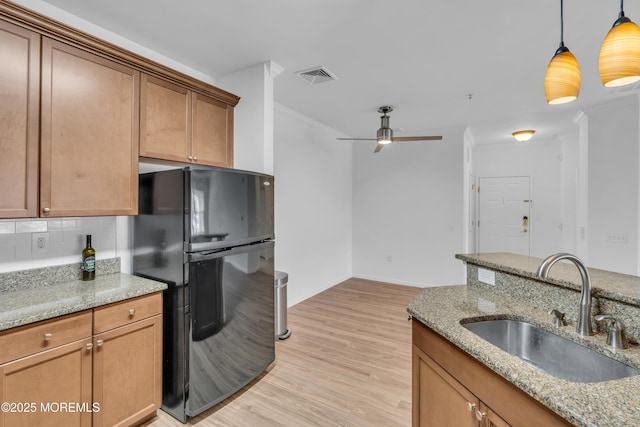 215 Sloan Ct, Matawan, NJ 07747 - kitchen featuring freestanding refrigerator, ceiling fan, backsplash, pendant lighting, and light wood-type flooring