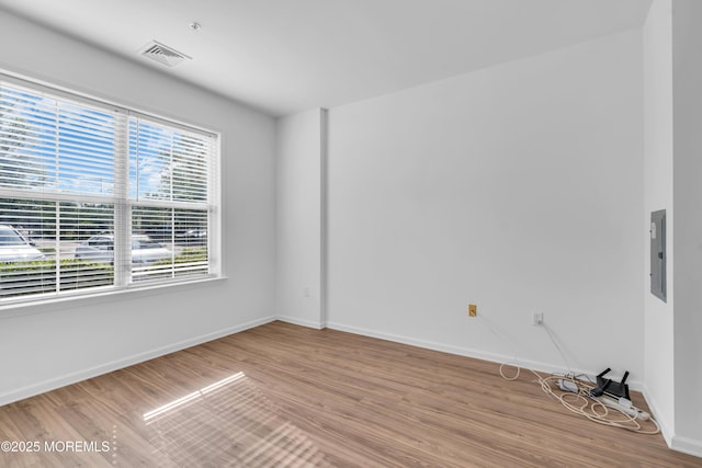 215 Sloan Ct, Matawan, NJ 07747 - spare room with electric panel and wood finished floors