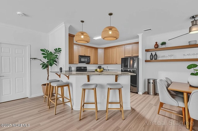 215 Sloan Ct, Matawan, NJ 07747 - kitchen with black appliances, light wood-style flooring, a kitchen breakfast bar, a peninsula, and pendant lighting