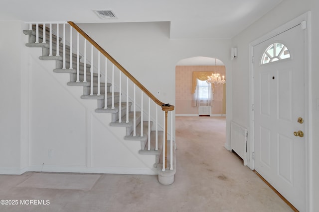 7 Tabor St, Little Silver, NJ 07739 - foyer featuring arched walkways, a chandelier, stairway, and radiator