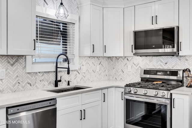 8 Blueberry Path, Howell, NJ 07731 - kitchen with appliances with stainless steel finishes, tasteful backsplash, light countertops, and white cabinets