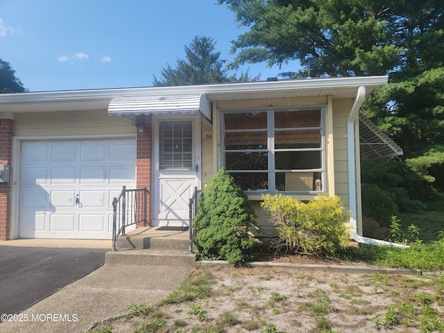 5B Lenape Dr, Whiting, NJ 08759 - view of front of home with brick siding, a garage, and driveway