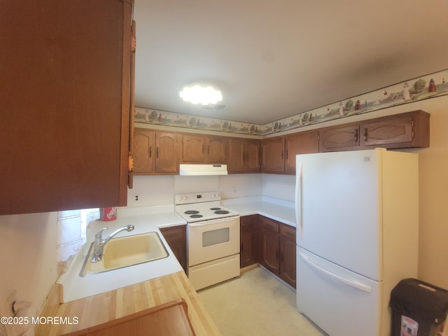 5B Lenape Dr, Whiting, NJ 08759 - kitchen featuring white appliances, under cabinet range hood, light countertops, brown cabinets, and light colored carpet