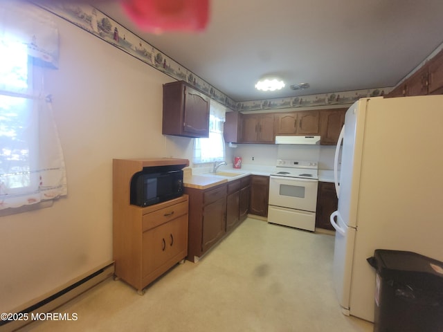 5B Lenape Dr, Whiting, NJ 08759 - kitchen featuring white appliances, a baseboard heating unit, under cabinet range hood, and light countertops
