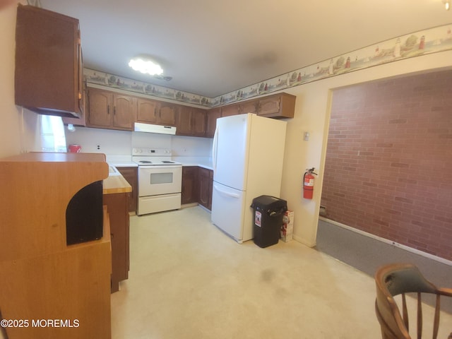 5B Lenape Dr, Whiting, NJ 08759 - kitchen with white appliances, brick wall, under cabinet range hood, light colored carpet, and light countertops