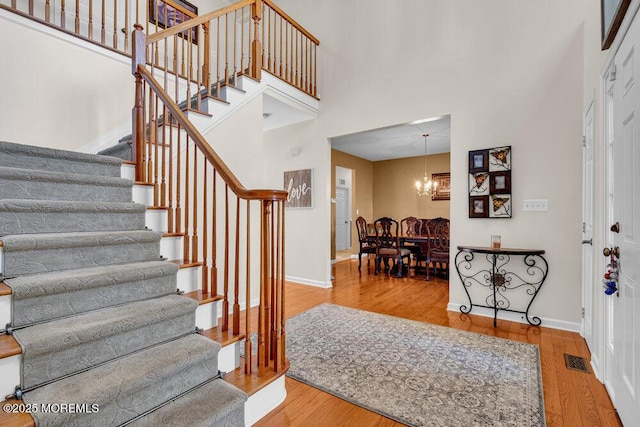 1 Opal Ct, Jackson, NJ 08527 - entrance foyer with stairway, wood finished floors, a chandelier, and a high ceiling