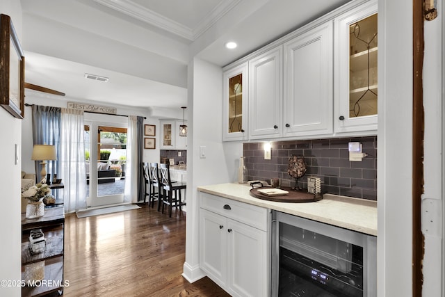 141 Twin Rivers Dr, Toms River, NJ 08753 - bar featuring wine cooler, crown molding, tasteful backsplash, dark wood-type flooring, and recessed lighting