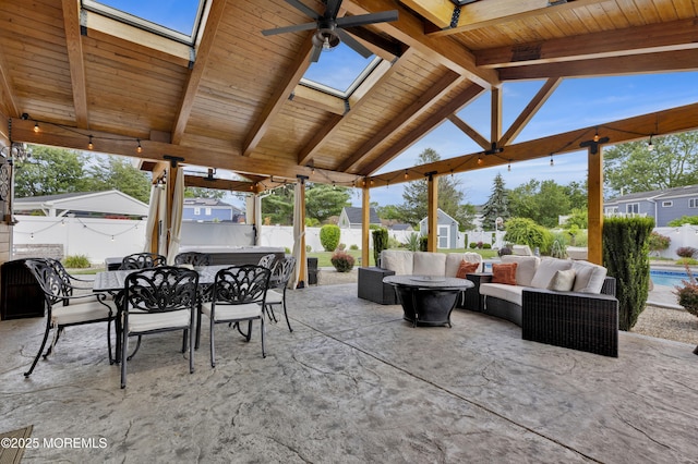 141 Twin Rivers Dr, Toms River, NJ 08753 - fenced backyard featuring an outdoor hangout area, outdoor dining area, a shed, ceiling fan, and a patio area