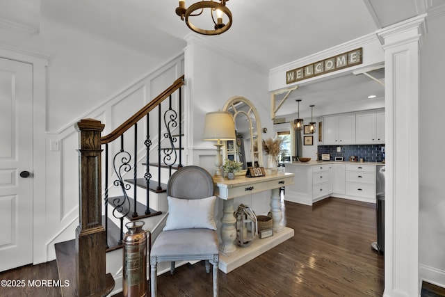 141 Twin Rivers Dr, Toms River, NJ 08753 - stairs featuring a decorative wall, crown molding, wood finished floors, and a chandelier