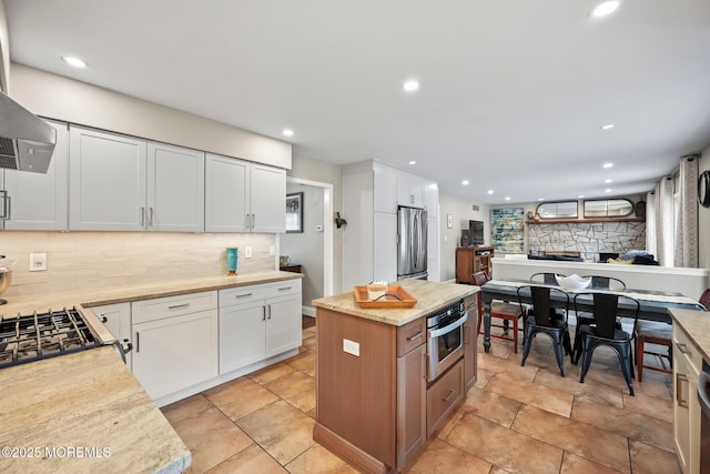 2 Independence Dr, Aberdeen, NJ 07747 - kitchen featuring appliances with stainless steel finishes, decorative backsplash, white cabinets, recessed lighting, and exhaust hood