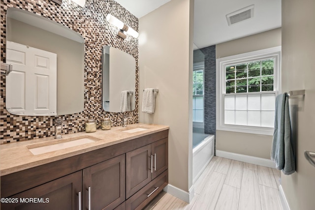 2 Independence Dr, Aberdeen, NJ 07747 - bathroom with double vanity, tasteful backsplash, and a tub