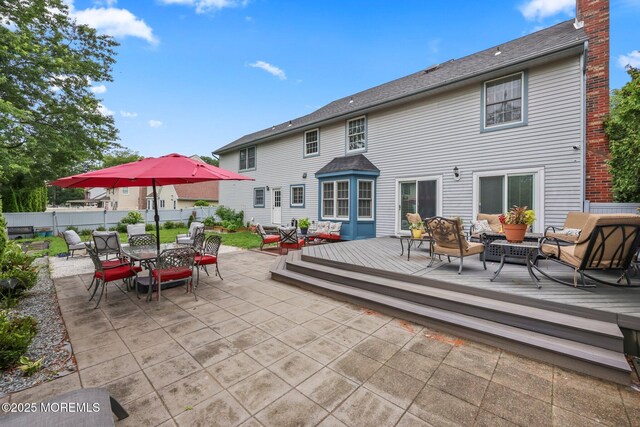 2 Independence Dr, Aberdeen, NJ 07747 - back of house with an outdoor hangout area, a deck, outdoor dining area, a chimney, and a patio area