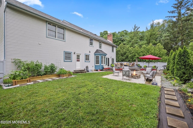2 Independence Dr, Aberdeen, NJ 07747 - rear view of house with a patio area, a chimney, a yard, entry steps, and an outdoor living space with a fire pit