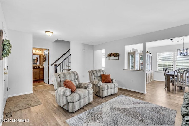85 Mapletree Rd, Toms River, NJ 08753 - living room featuring a chandelier, light wood-style flooring, and stairway
