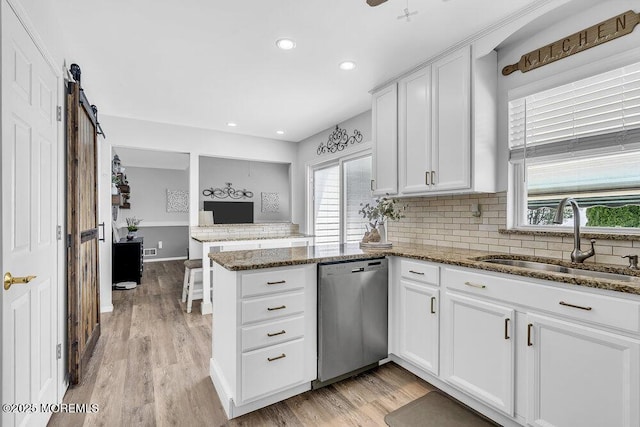 85 Mapletree Rd, Toms River, NJ 08753 - kitchen with stainless steel dishwasher, a peninsula, tasteful backsplash, light wood-style floors, and recessed lighting