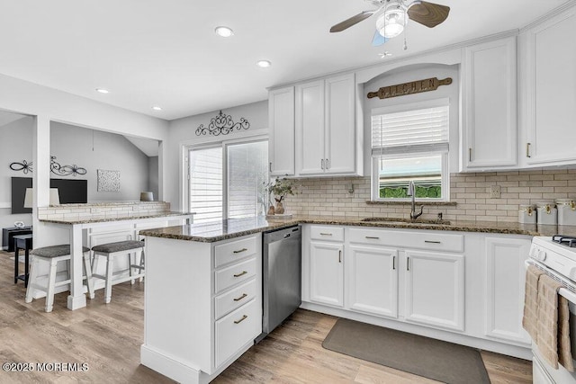 85 Mapletree Rd, Toms River, NJ 08753 - kitchen with stainless steel dishwasher, a peninsula, gas range gas stove, white cabinetry, and recessed lighting