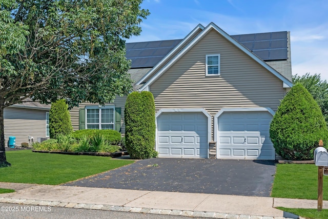 252 Enclave Blvd, Lakewood, NJ 08701 - view of front of property featuring driveway, a front lawn, and roof mounted solar panels