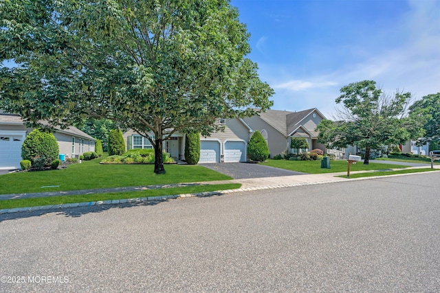 252 Enclave Blvd, Lakewood, NJ 08701 - view of property hidden behind natural elements with driveway, a front yard, a garage, and a residential view