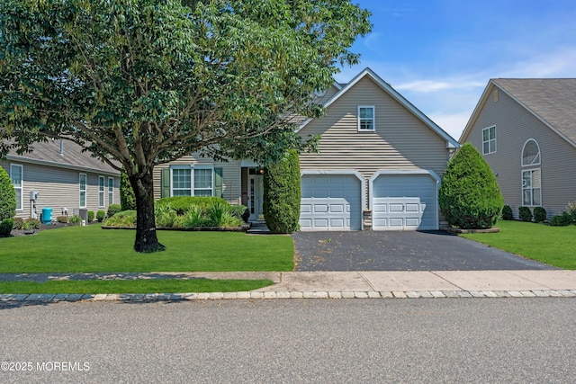 252 Enclave Blvd, Lakewood, NJ 08701 - view of property hidden behind natural elements with driveway, a front yard, and an attached garage