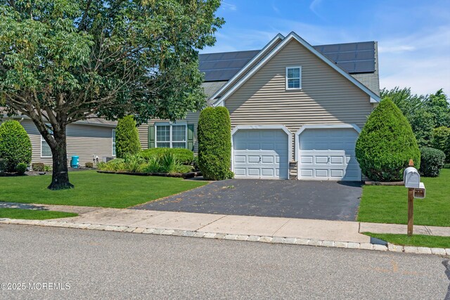 252 Enclave Blvd, Lakewood, NJ 08701 - traditional-style house with driveway, a front yard, solar panels, and a garage