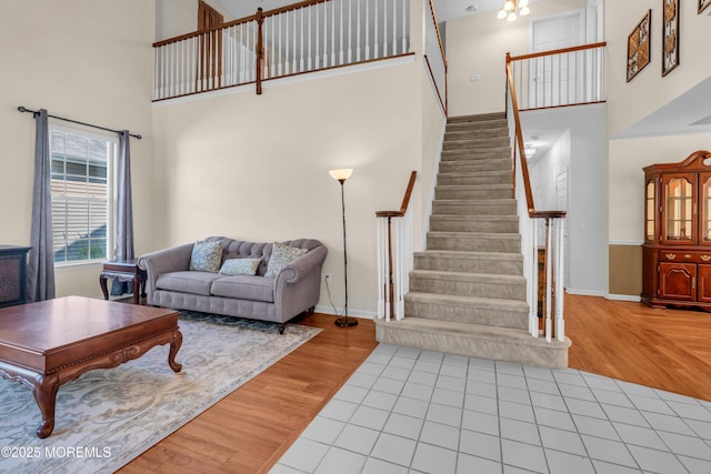 252 Enclave Blvd, Lakewood, NJ 08701 - living room featuring a towering ceiling, stairs, and wood finished floors