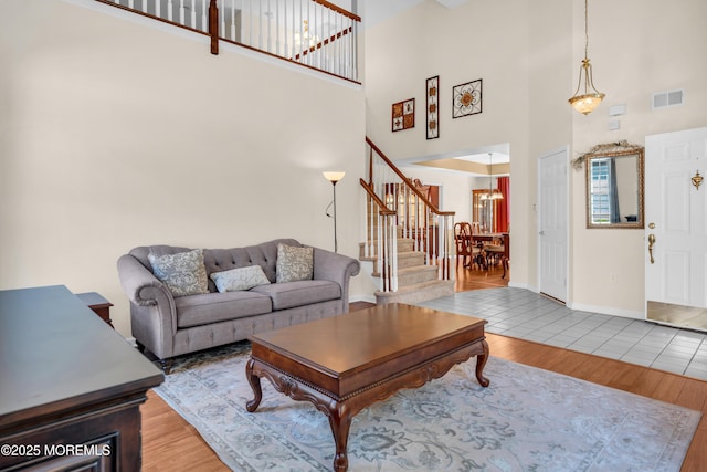 252 Enclave Blvd, Lakewood, NJ 08701 - living room featuring a high ceiling, stairway, wood finished floors, and a chandelier