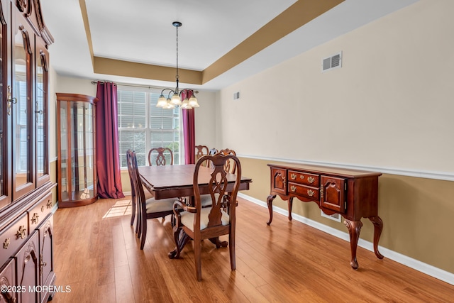 252 Enclave Blvd, Lakewood, NJ 08701 - dining room featuring a tray ceiling, a chandelier, and light wood-type flooring