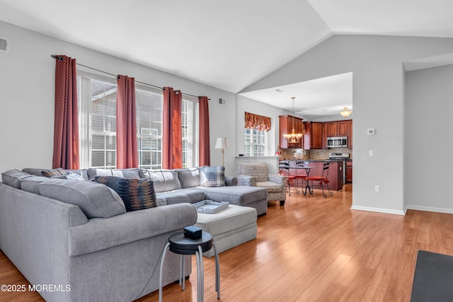 252 Enclave Blvd, Lakewood, NJ 08701 - living area with a chandelier, vaulted ceiling, and light wood-style flooring