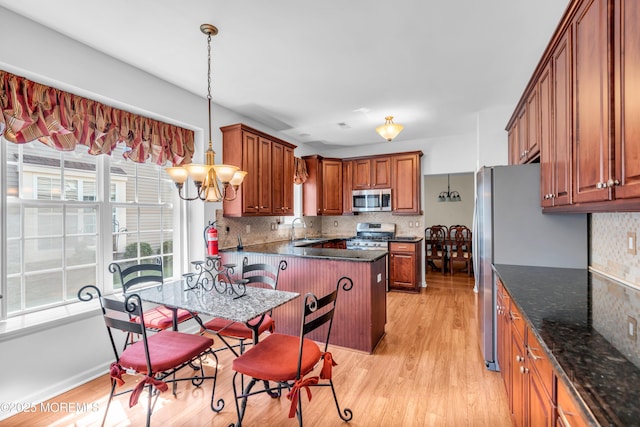 252 Enclave Blvd, Lakewood, NJ 08701 - kitchen featuring stainless steel appliances, decorative backsplash, and brown cabinetry