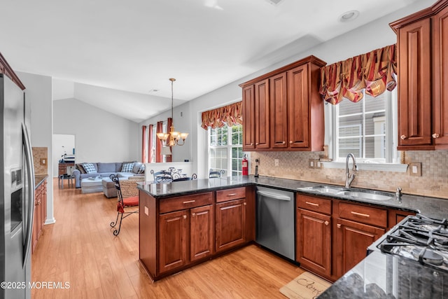 252 Enclave Blvd, Lakewood, NJ 08701 - kitchen with appliances with stainless steel finishes, light wood-style floors, open floor plan, decorative backsplash, and a peninsula