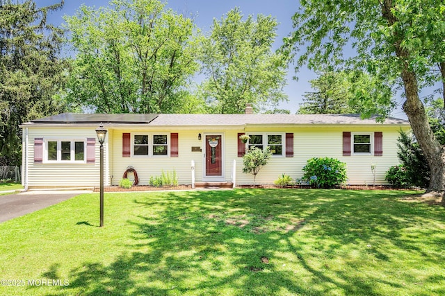 6 Redwood Rd, Howell, NJ 07731 - ranch-style house featuring solar panels, a chimney, and a front lawn