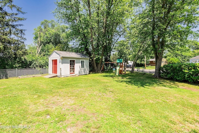 6 Redwood Rd, Howell, NJ 07731 - fenced backyard with a playground, a storage unit, and view of scattered trees
