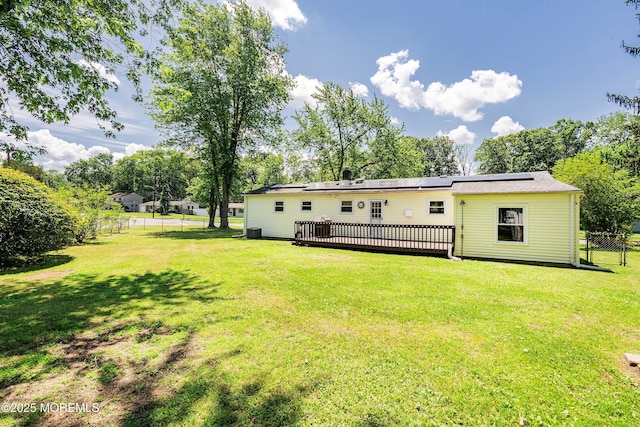 6 Redwood Rd, Howell, NJ 07731 - rear view of property featuring a wooden deck and solar panels