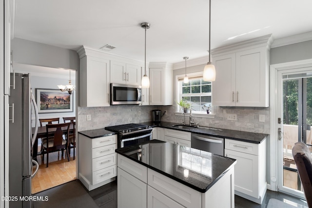 86 Lorelei Dr, Howell, NJ 07731 - kitchen featuring appliances with stainless steel finishes, decorative backsplash, white cabinets, a chandelier, and ornamental molding