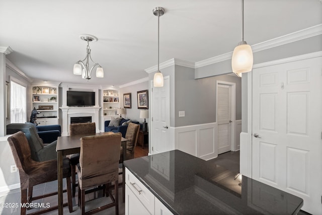 86 Lorelei Dr, Howell, NJ 07731 - dining area with ornamental molding, a fireplace, wainscoting, and built in features