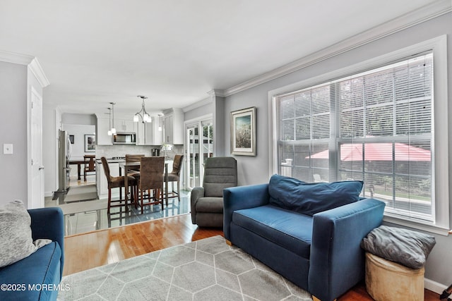 86 Lorelei Dr, Howell, NJ 07731 - living area with plenty of natural light, crown molding, light wood-style flooring, and a chandelier