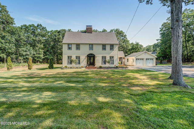 215 Parkertown Dr, Little Egg Harbor, NJ 08087 - colonial inspired home with a chimney, a front yard, a detached garage, and an outbuilding