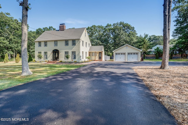 215 Parkertown Dr, Little Egg Harbor, NJ 08087 - colonial-style house with an outbuilding, a chimney, a detached garage, a shingled roof, and a front yard