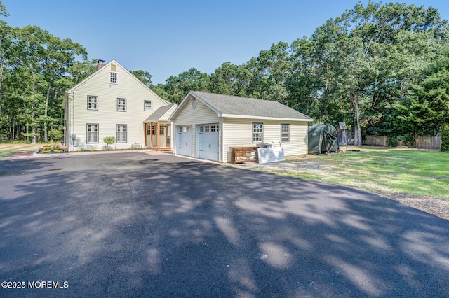 215 Parkertown Dr, Little Egg Harbor, NJ 08087 - view of front of house featuring a chimney, a garage, an outbuilding, and view of scattered trees