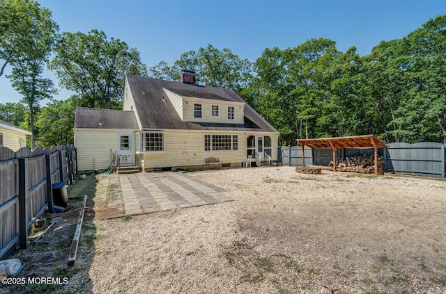 215 Parkertown Dr, Little Egg Harbor, NJ 08087 - rear view of house featuring entry steps, a fenced backyard, a chimney, and a patio
