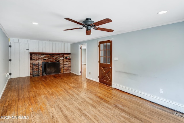 215 Parkertown Dr, Little Egg Harbor, NJ 08087 - unfurnished living room with baseboard heating, ceiling fan, wood finished floors, ornamental molding, and a fireplace