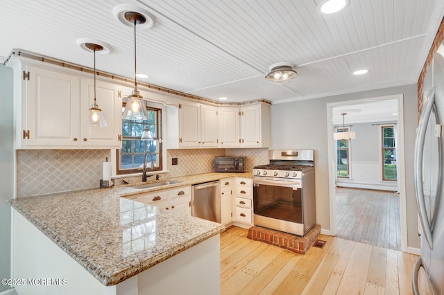 215 Parkertown Dr, Little Egg Harbor, NJ 08087 - kitchen featuring stainless steel appliances, light stone countertops, a peninsula, pendant lighting, and plenty of natural light