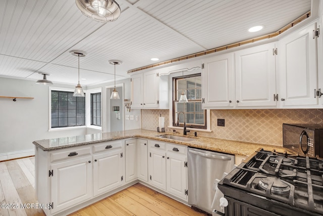 215 Parkertown Dr, Little Egg Harbor, NJ 08087 - kitchen featuring black appliances, a peninsula, light stone counters, white cabinets, and recessed lighting