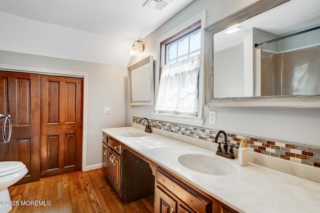 215 Parkertown Dr, Little Egg Harbor, NJ 08087 - full bath featuring plenty of natural light, double vanity, hardwood / wood-style floors, and tasteful backsplash