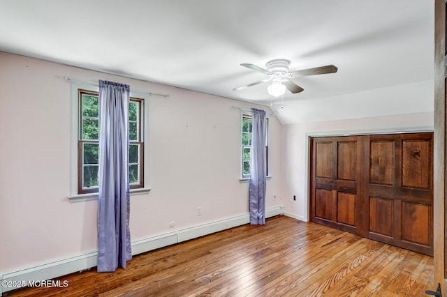 215 Parkertown Dr, Little Egg Harbor, NJ 08087 - unfurnished bedroom with baseboard heating, light wood-type flooring, lofted ceiling, and a ceiling fan