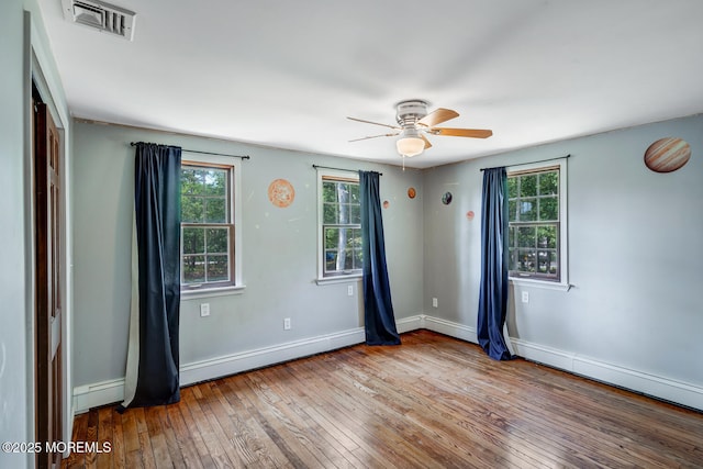 215 Parkertown Dr, Little Egg Harbor, NJ 08087 - unfurnished room with baseboard heating, plenty of natural light, hardwood / wood-style floors, and a ceiling fan