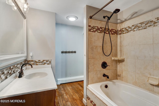 215 Parkertown Dr, Little Egg Harbor, NJ 08087 - full bathroom with baseboard heating, vanity, shower / washtub combination, wood finished floors, and decorative backsplash
